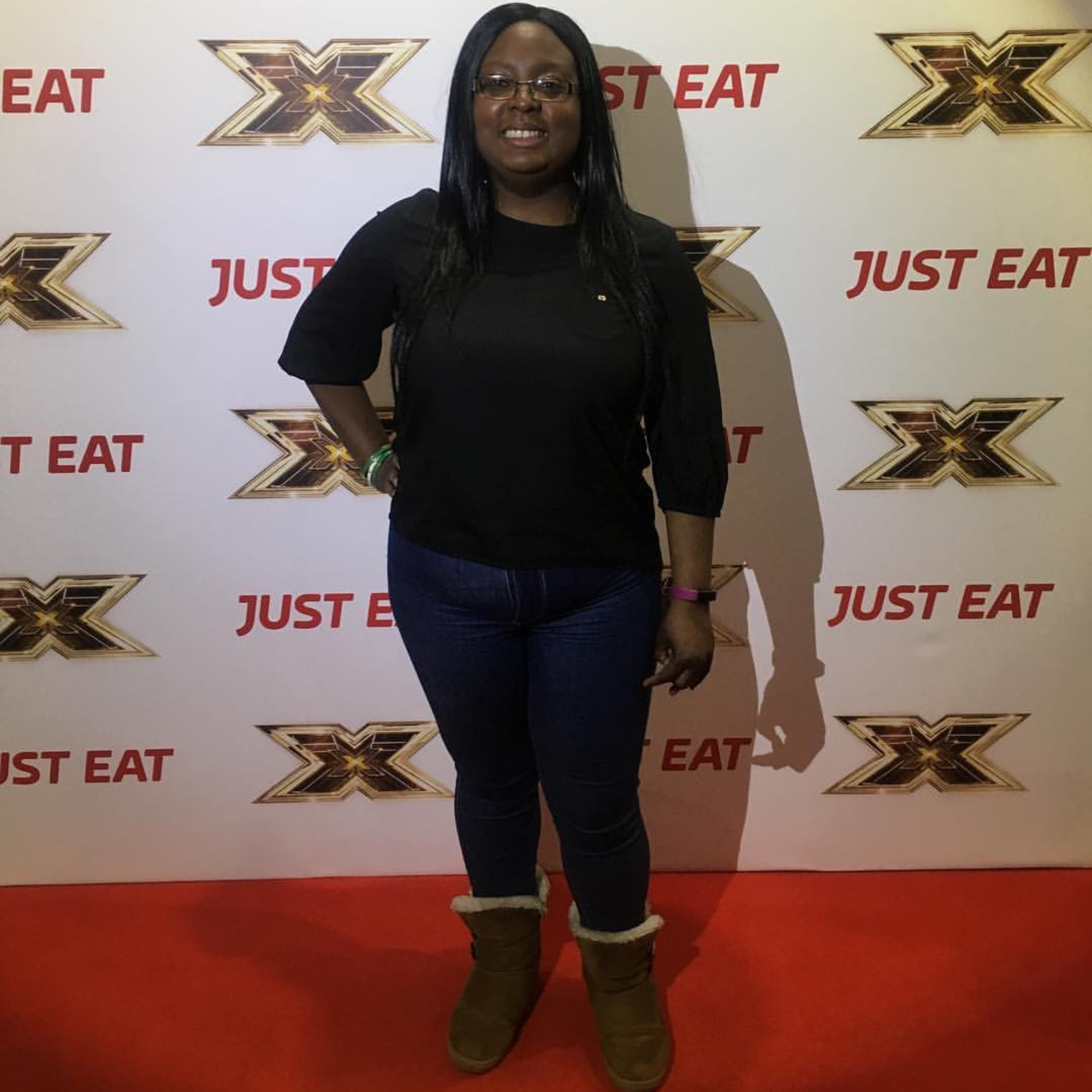 Nefe standing confidently at a media event (X factor), marking an early chapter in her personal journey.