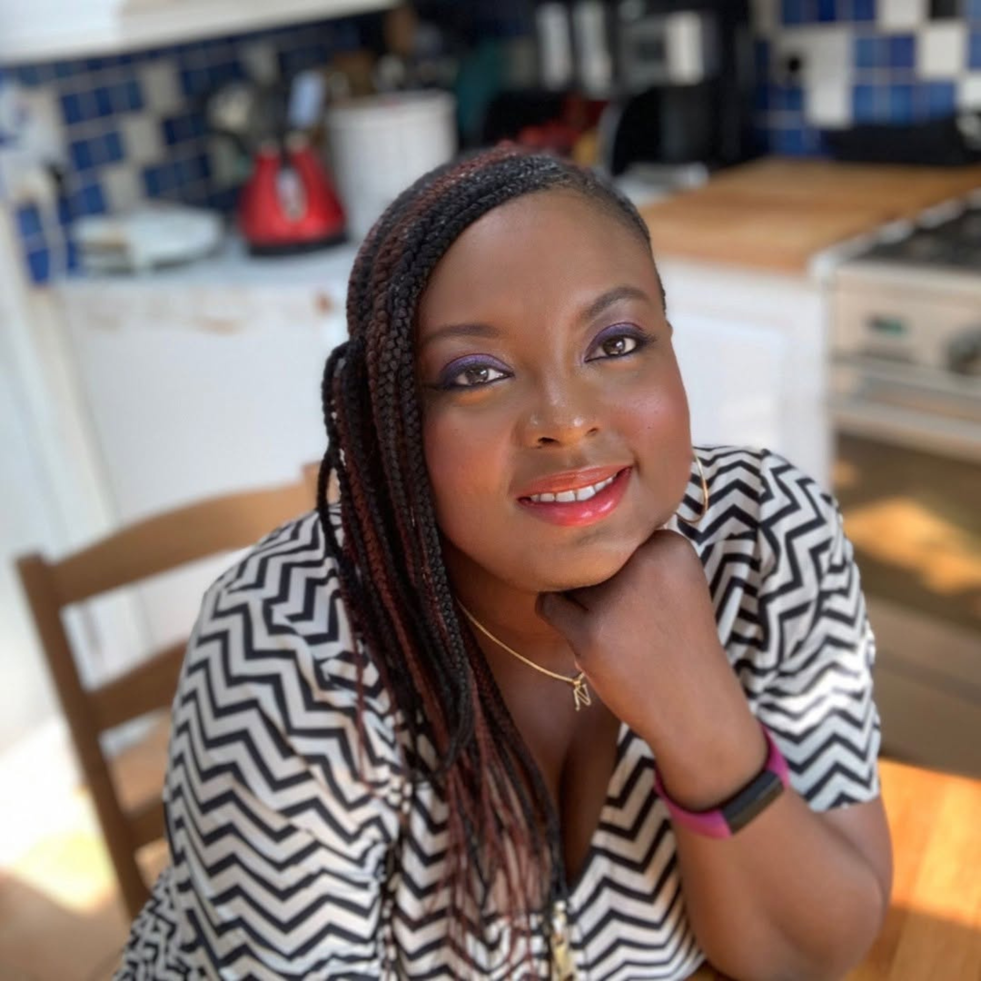 Nefe resting her chin on her hand at home, reflecting during a period of change.