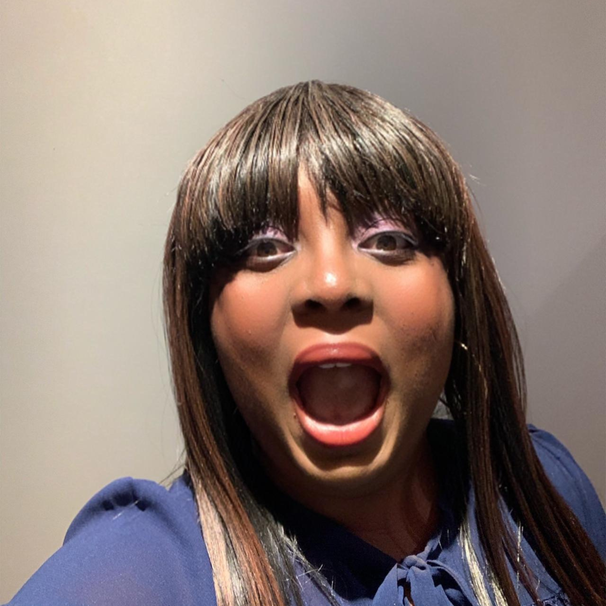 Nefe making a playful surprised expression while looking at the camera.