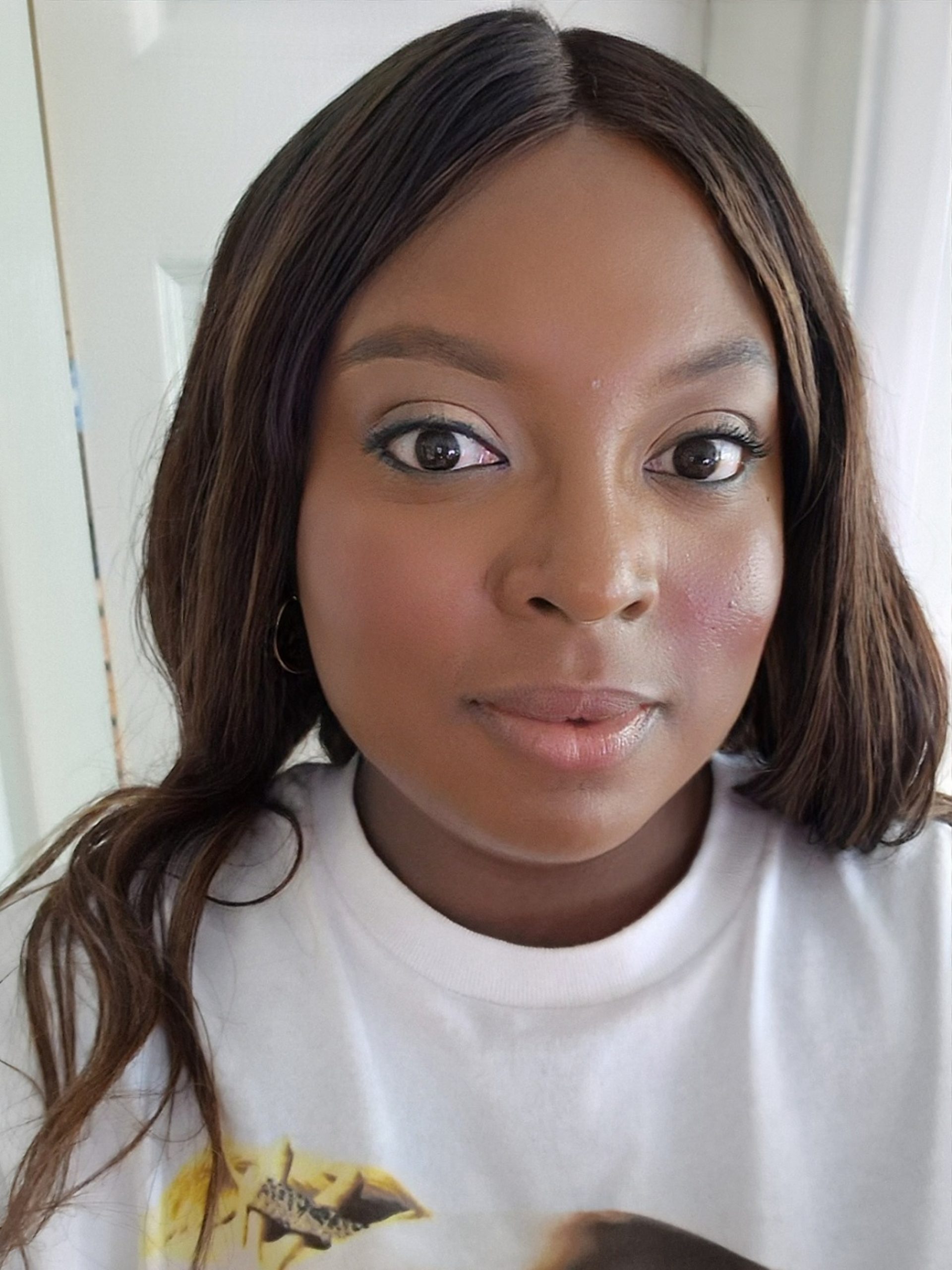 Close-up portrait of Nefe Oguntoye with natural makeup, photographed indoors in soft light.