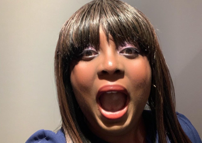 Close-up portrait of Nefe Oguntoye with an expressive surprised reaction.